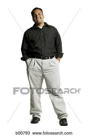 Portrait of a young man standing with his hands in his pockets View Large Photo Image Stock Image - Portrait of a young man standing with his hands in his pockets. Fotosearch
