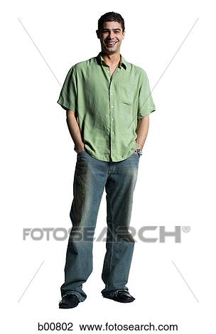 Stock Image - Portrait of a young man standing with his hands in his pockets. Fotosearch