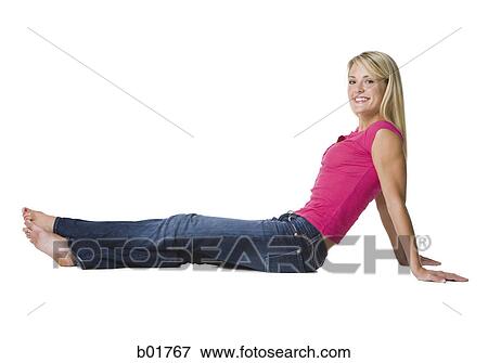 Profile of a young woman sitting on the floor View Large Photo Image Stock Photo - Profile of a young woman sitting on the floor. Fotosearch