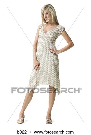 Young woman standing and smiling View Large Photo Image Stock Photo - Young woman standing and smiling. Fotosearch