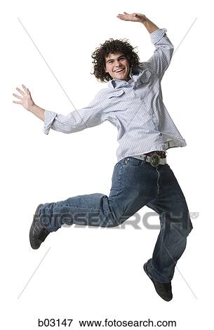 Portrait of a teenage boy jumping in mid-air View Large Photo Image Stock Photo - Portrait of a teenage boy jumping in mid-air. Fotosearch
