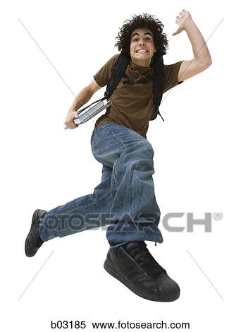Portrait of a teenage boy making a face and jumping in mid-air View Large Photo Image Stock Photography - Portrait of a teenage boy making a face and jumping in mid-air. Fotosearch