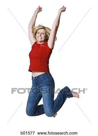 Portrait of a woman jumping with her arms raised View Large Photo Image Stock Photo - Portrait of a woman jumping with her arms raised. Fotosearch