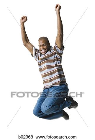 Portrait of a young man jumping in mid-air View Large Photo Image Stock Photo - Portrait of a young man jumping in mid-air. Fotosearch