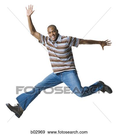 Stock Photo - Portrait of a young man jumping in mid-air. Fotosearch
