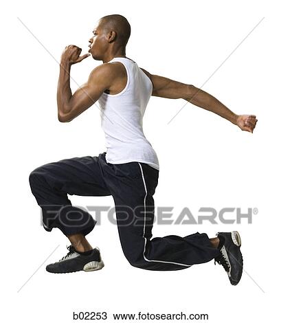 Stock Image - Portrait of a young man running. Fotosearch