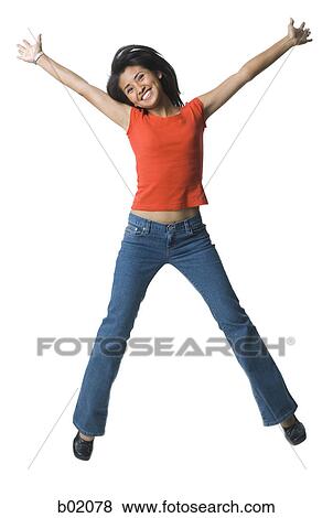 Stock Photo - Portrait of a young woman jumping. Fotosearch