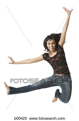 Portrait of a young woman jumping with her hand raised View Large Photo Image Stock Photography - Portrait of a young woman jumping with her hand raised. Fotosearch