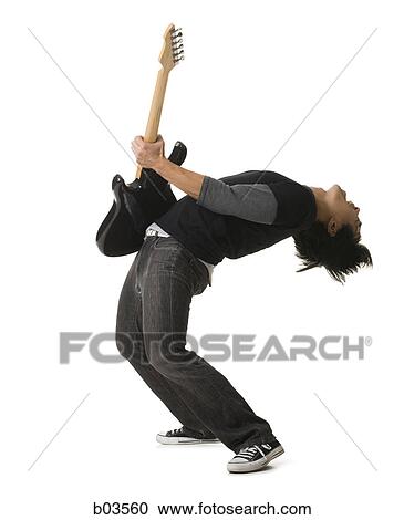 Stock Image - Portrait of a young woman standing with her arms folded. Fotosearch