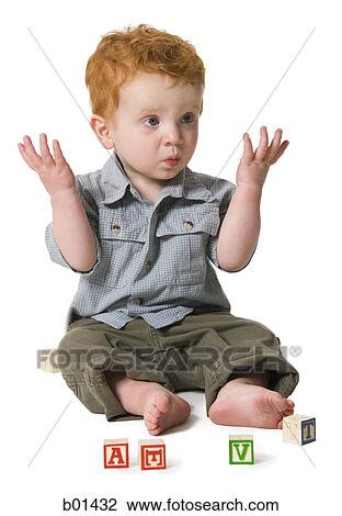 Baby boy sitting on the floor with building blocks View Large Photo Image Stock Image - Baby boy sitting on the floor with building blocks. Fotosearch