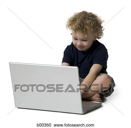 Boy using a laptop View Large Photo Image Stock Image - Boy using a laptop. Fotosearch