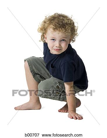 Stock Photo - Portrait of a boy crouching. Fotosearch