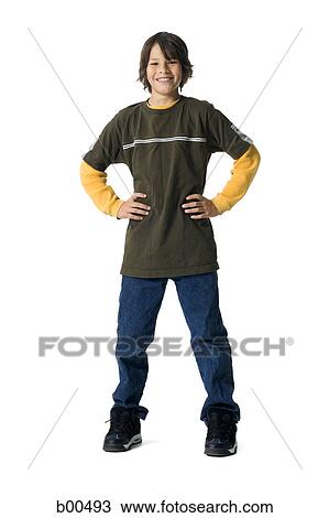 Portrait of a boy standing with arms akimbo View Large Photo Image Stock Image - Portrait of a boy standing with arms akimbo. Fotosearch