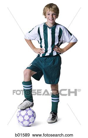 Stock Photo - Portrait of a boy with his foot on a soccer ball. Fotosearch