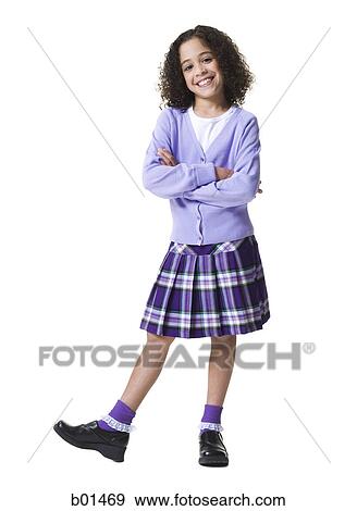Stock Photo - Portrait of a girl standing with her arms crossed. Fotosearch