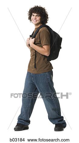 Portrait of a teenage boy carrying a bag and smiling View Large Photo Image Picture - Portrait of a teenage boy carrying a bag and smiling. Fotosearch