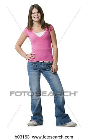 Portrait of a teenage girl standing with hand on hip View Large Photo Image Stock Image - Portrait of a teenage girl standing with hand on hip. Fotosearch