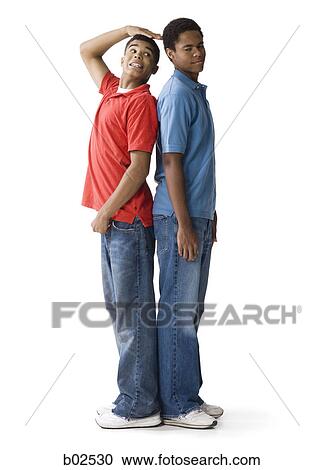 Profile of a teenage boy and a young man standing back to back View Large Photo Image Stock Image - Profile of a teenage boy and a young man standing back to back. Fotosearch