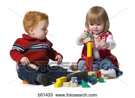 Stock Image - Two children playing with building blocks. Fotosearch