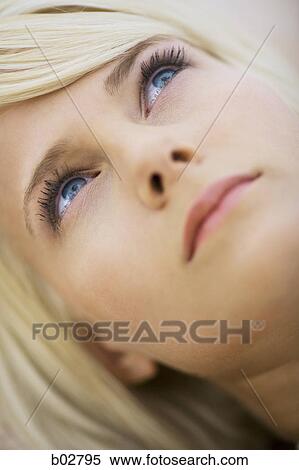 Close-up of a young woman looking up View Large Photo Image Stock Photography - Close-up of a young woman looking up. Fotosearch