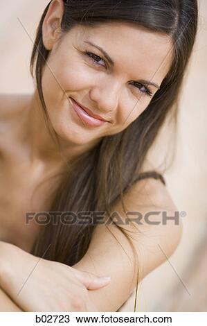 Close-up of a young woman smiling View Large Photo Image Stock Image - Close-up of a young woman smiling. Fotosearch