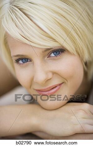 Close-up of a young woman smiling View Large Photo Image Stock Image - Close-up of a young woman smiling. Fotosearch