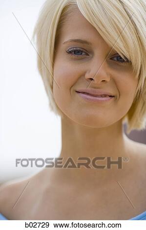 Close-up of a young woman smiling View Large Photo Image Stock Photo - Close-up of a young woman smiling. Fotosearch