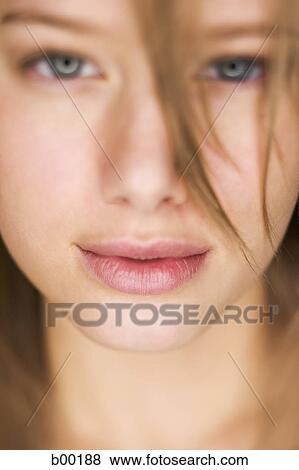 Close-up of a young woman's face View Large Photo Image Stock Photo - Close-up of a young woman's face. Fotosearch