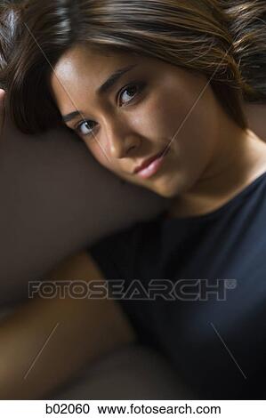 High angle view of a young woman smiling View Large Photo Image Stock Image - High angle view of a young woman smiling. Fotosearch