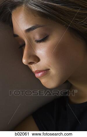 High angle view of a young woman sleeping View Large Photo Image Stock Image - High angle view of a young woman sleeping. Fotosearch