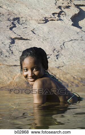 Stock Photo - Portrait of a young woman in a lake. Fotosearch