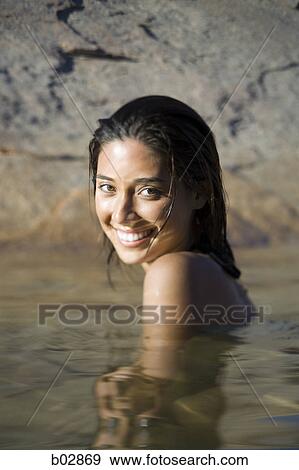 Stock Photo - Portrait of a young woman in a lake. Fotosearch