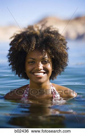 Portrait of a young woman in water, smiling View Large Photo Image Stock Photograph - Portrait of a young woman in water, smiling. Fotosearch