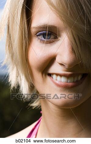 Portrait of a young woman smiling View Large Photo Image Picture - Portrait of a young woman smiling. Fotosearch