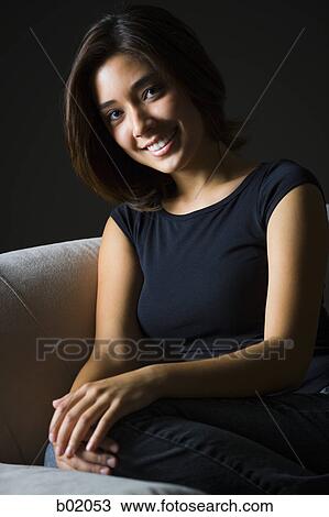 Portrait of a young woman smiling View Large Photo Image Stock Image - Portrait of a young woman smiling. Fotosearch