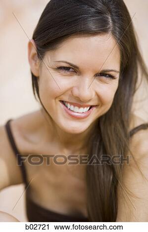Portrait of a young woman smiling View Large Photo Image Stock Image - Portrait of a young woman smiling. Fotosearch