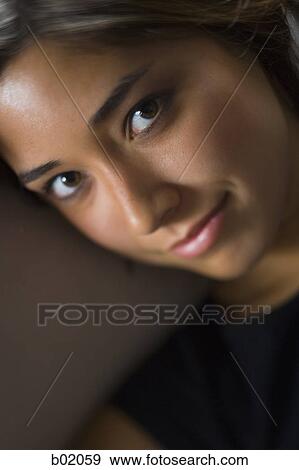 Stock Photo - Portrait of a young woman smiling. Fotosearch