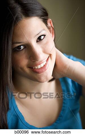 Portrait of a young woman smiling View Large Photo Image Stock Photograph - Portrait of a young woman smiling. Fotosearch