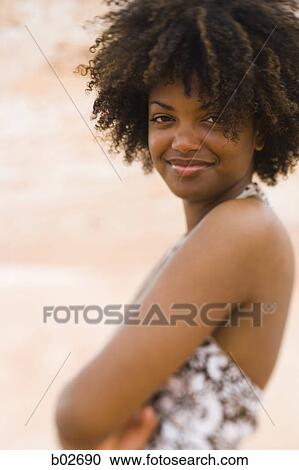 Stock Image - Profile of a young woman smiling. Fotosearch