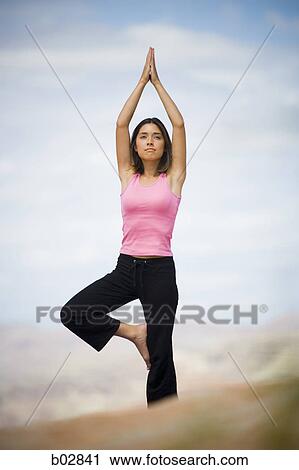 Low angle view of a young woman doing yoga View Large Photo Image Stock Image - Low angle view of a young woman doing yoga. Fotosearch