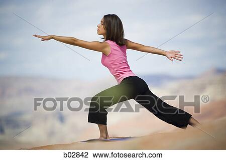 Stock Image - Profile of a young woman exercising. Fotosearch