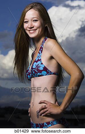 Profile of a young woman in a bikini View Large Photo Image Stock Photo - Profile of a young woman in a bikini. Fotosearch