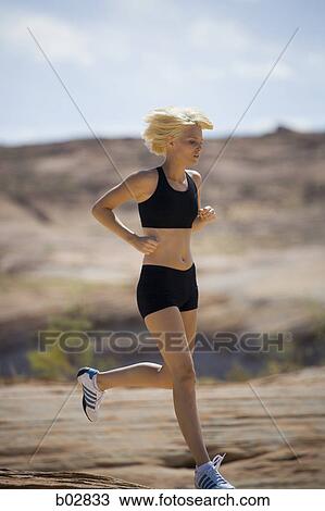 Profile of a young woman jogging View Large Photo Image Stock Image - Profile of a young woman jogging. Fotosearch