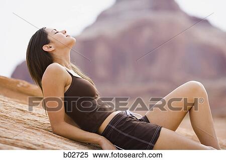 Stock Photography - Profile of a young woman lying on her back. Fotosearch