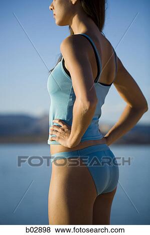 Profile of a young woman standing on the bank of a lake View Large Photo Image Stock Photo - Profile of a young woman standing on the bank of a lake. Fotosearch