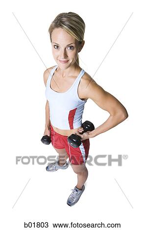 High angle view of a young woman holding dumbbells View Large Photo Image Stock Image - High angle view of a young woman holding dumbbells. Fotosearch