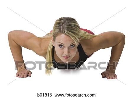 Portrait of a young woman doing push-ups View Large Photo Image Stock Photography - Portrait of a young woman doing push-ups. Fotosearch