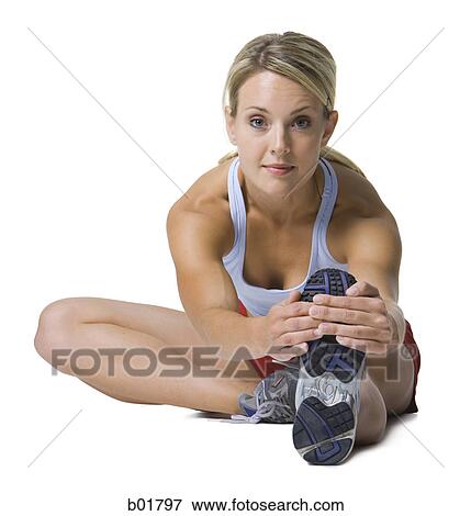 Stock Photo - Portrait of a young woman exercising. Fotosearch