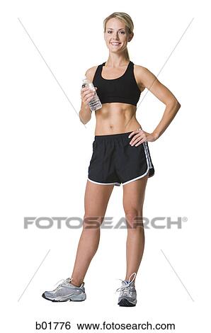 Portrait of a young woman in sports clothing View Large Photo Image Stock Photograph - Portrait of a young woman in sports clothing. Fotosearch