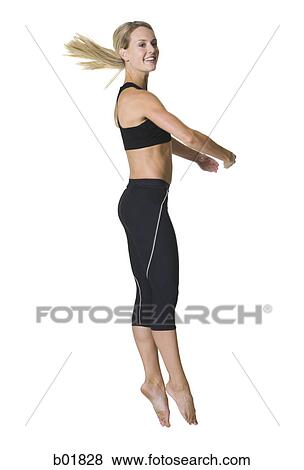 Portrait of a young woman jumping View Large Photo Image Stock Photo - Portrait of a young woman jumping. Fotosearch
